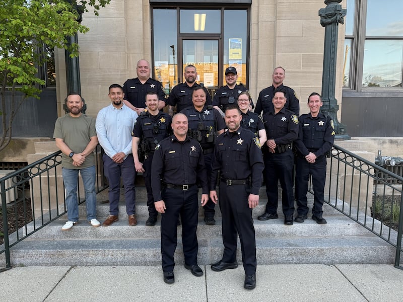 Members of the Ottawa Police Department pose for a photo outside City Hall on Tuesday, May 6, 2025. Officers were recognized during the City Council meeting for years of service as part of National Police Week.