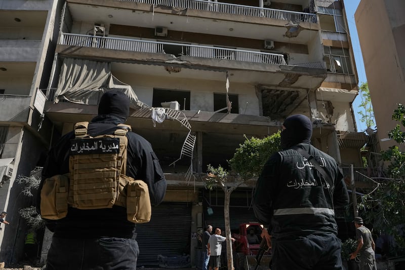 Members of the Lebanese Army Intelligence stand guard in front of an apartment that was struck in an Israeli airstrike in Dahiyeh, Beirut's southern suburbs, Lebanon, Sunday, June 14, 2026. (AP Photo/Bilal Hussein)