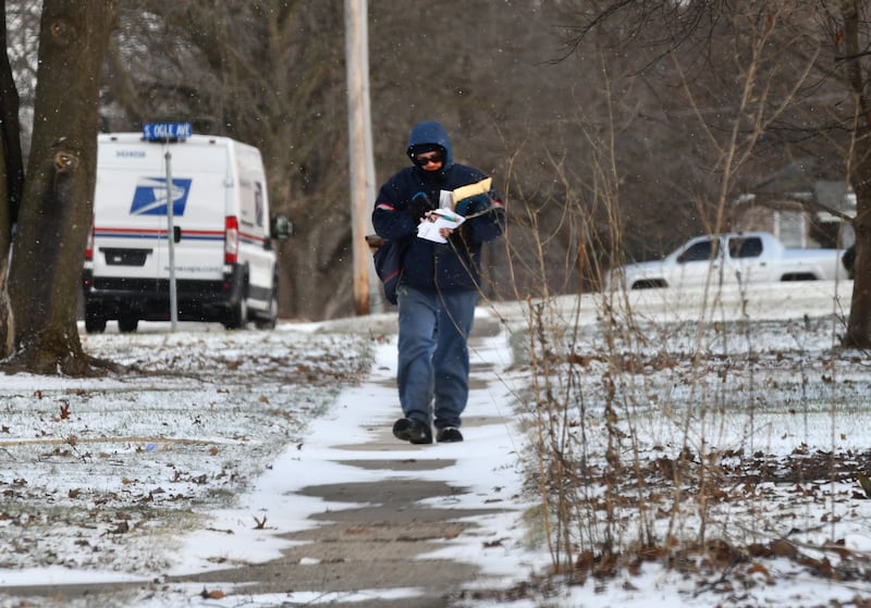 Mail carrier Logan Miller makes deliveries on Lincoln Street in Mt. Morris as light snow falls on Monday, Dec. 29, 2025. Winter returned to the Ogle County region over the weekend with temperatures dropping below freezing.