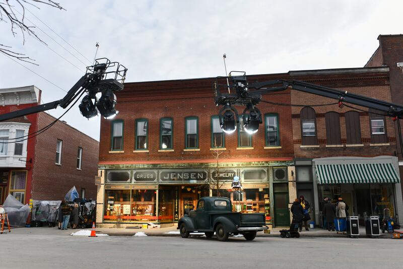 Large lights and old cars line East Washington Street in downtown Momence during the filming of Netflix's Monster series on Feb. 11, 2025.
