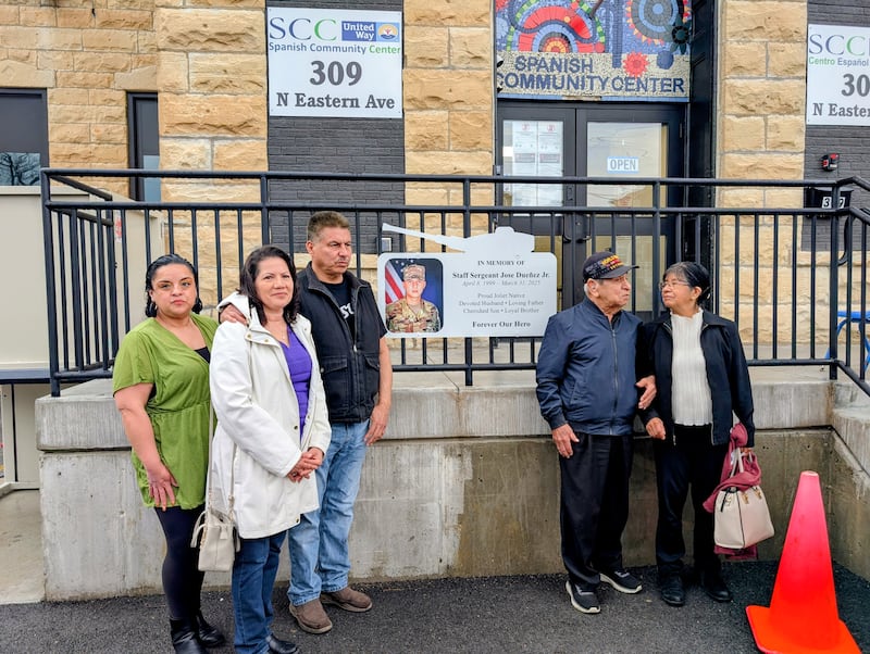 Family and friends of the late Staff Sgt. Jose Duenez Jr. gather outside the Spanish Community Center in Joliet as a sign was posted to honor Duenez. March 31, 2026