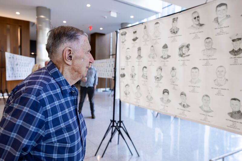 Crest Hill resident Frank Rzonca takes in the 'Portrait of a Soldier’ exhibit at the Will County Courthouse in Joliet, Illinois, on Sept. 11, 2025.
