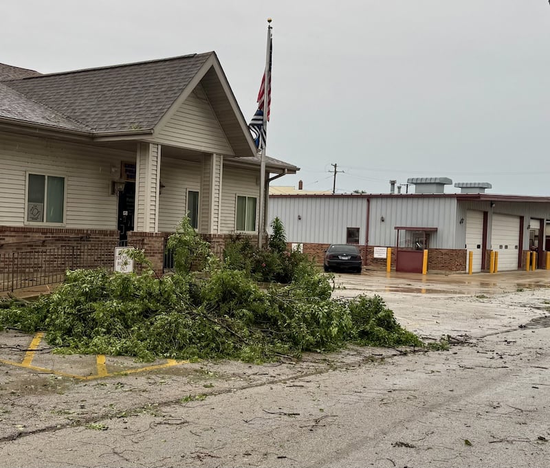 Tree branches damaged by Wednesday's storm lie across the front lawn of Seneca's municipal building. The storm left debris scattered throughout the city.