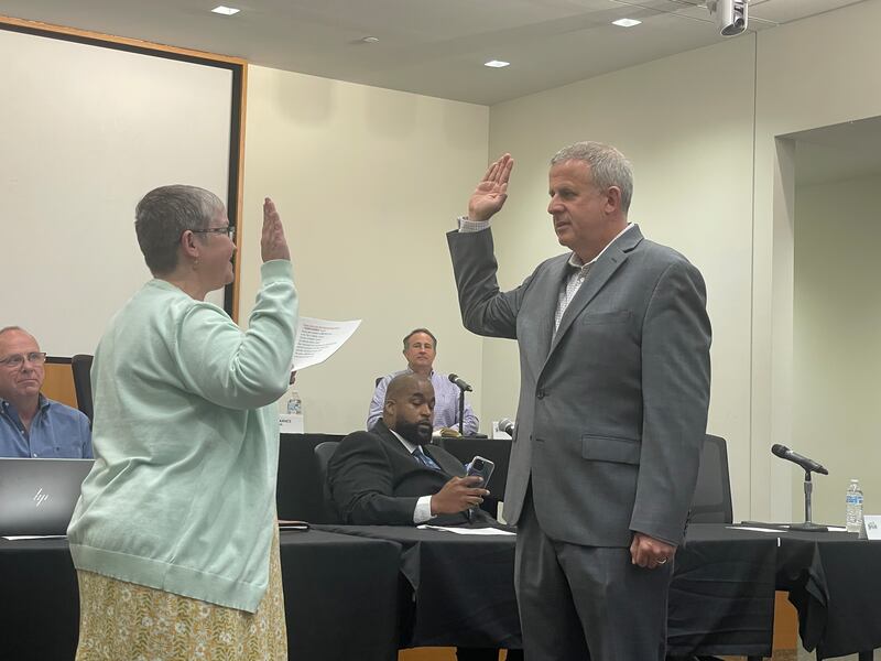 DeKalb Mayor Cohen Barnes (right) is sworn in May 12, 2025, at the DeKalb City Council meeting.