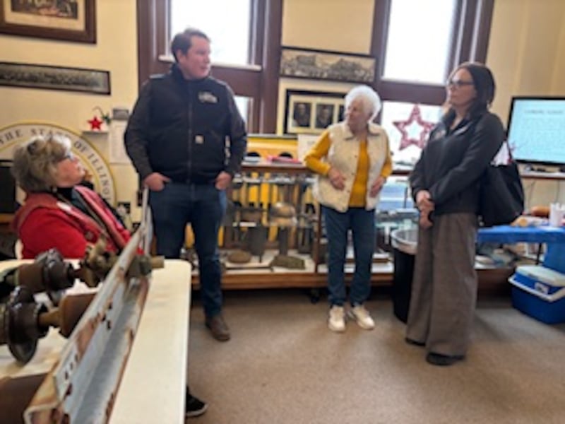 Vicki Snyder-Chura, Rep. Brad Fritts, Bobbie Colbert and Piper Grazulis in the Military Room at the Flagg Township Museum.