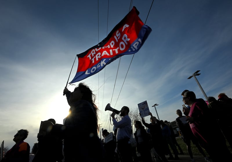 Hundreds gathered on the curb on Ogden Ave. in front of a Tesla dealership to demonstrate, led by Reid McCullum using a blowhorn on Tuesday, March 18, 2025. He is the Chairman of the Democratic Party of DuPage County.