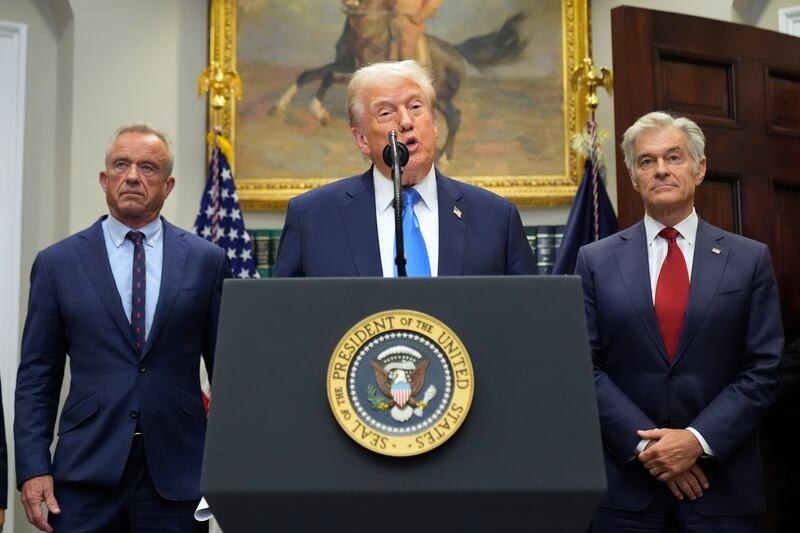 President Donald Trump speaks in the Roosevelt Room of the White House, Monday, Sept. 22, 2025, in Washington, as Health and Human Services Secretary Robert F. Kennedy Jr., left, and Centers for Medicare & Medicaid Services administrator Dr. Mehmet Oz listen. (AP Photo/Mark Schiefelbein)