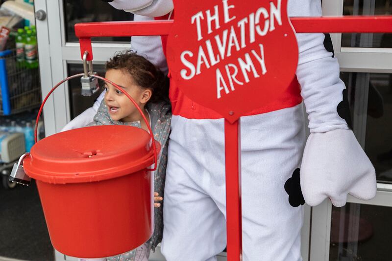 Simona Anderson, 4, of Tampico grabs a hug from Marshal Thursday, Nov. 20, 2025, outside of the Sterling Walmart. The police and fire departments went head to head in donation collections to help benefit the Salvation Army.