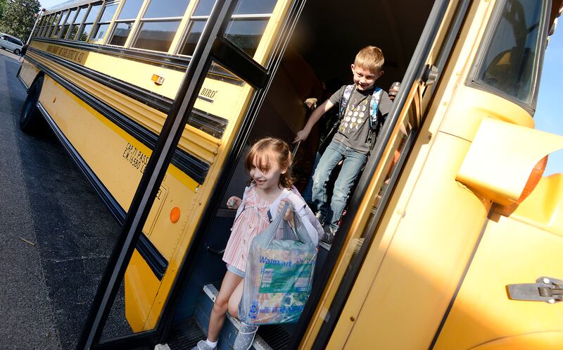 It is all smiles for kids getting off the bus on the first day of school at Haskin Elementary in Sandwich on Wednesday, Aug. 17, 2023.