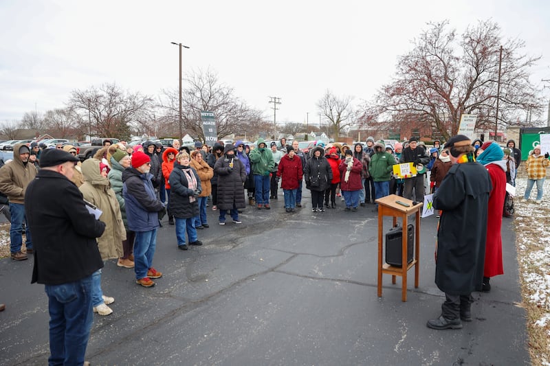 Pastors Robert Bushey and Lana Robyne, at right, lead a crowd of about 100 in a song during an ICE Out for Good protest and vigil at The Grow Center in Bourbonnais on Sunday, Jan. 11, 2026. The event was planned in the wake of the shooting death of Renee Nicole Good by an ICE agent on Jan. 7 in Minneapolis, Minn.