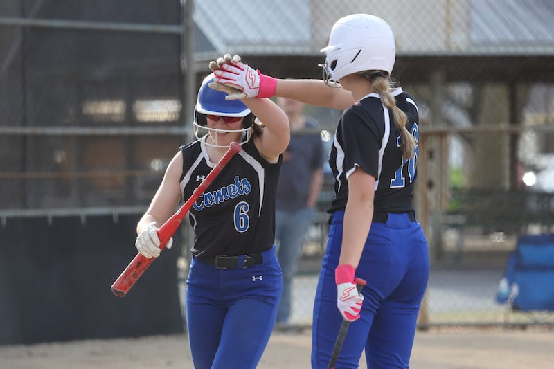 Central's Lia Prairie is congratulated by teammate Mia Koch-Perzee after Prairie's inside-the-park homerun during the Comets' 9-2 victory over Gardner-South Wilmington on Tuesday, April 22. The win keeps Central's perfect River Valley Conference record intact.