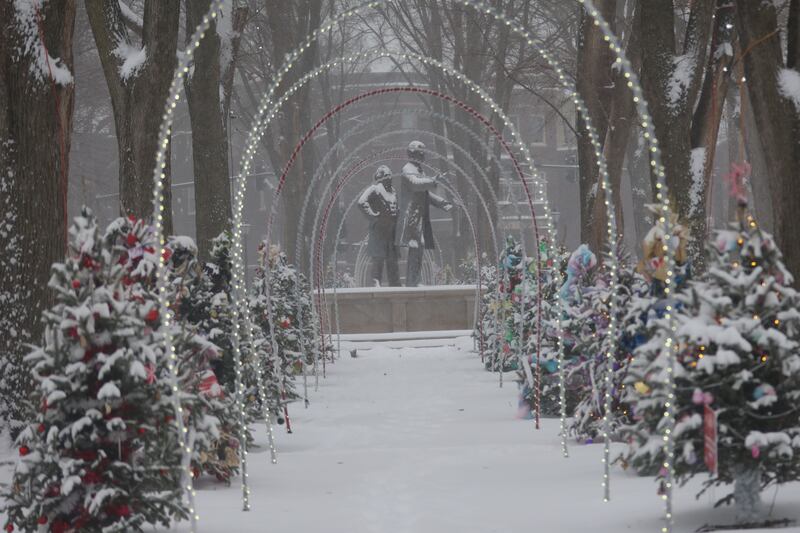 An arch of lights and Christmas trees line Washington Park near the Lincoln and Dougles statues on Saturday, Nov. 29, 2025 downtown Ottawa.