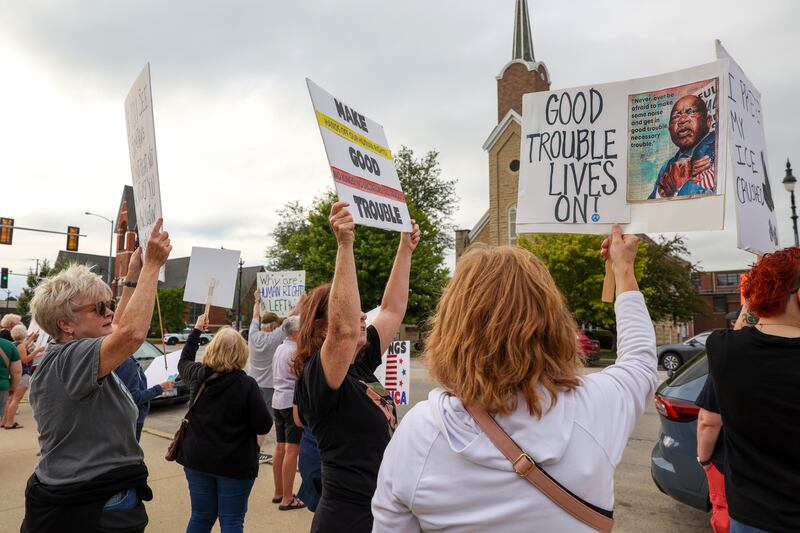 Protestors hold signs in reference to the late civil rights leader and congressman John Lewis during a "Good Trouble Lives On" rally held in Kankakee as part of a national day of peaceful protests on Thursday, July 17, 2025.