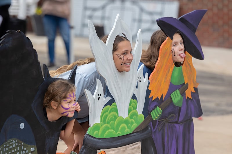 Jaylea Avila (left), 5, Zadie Barber, 13, and Lyndie Kastner, 13, of Dixon have their picture taken in a Halloween display Saturday, Oct. 18, 2025, at Dixon’s Scarecrow Fest. The annual event was as popular as ever, bringing hundreds to the downtown to enjoy food, art, dancing and all things Halloween.
