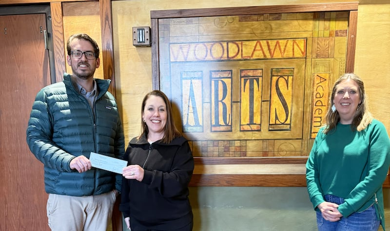 Adam Czamanske (left) and Anne-Marie Williams (right) of Prairie Brome Solar present a check to Woodlawn Arts Academy Executive Director Christy Zepezauer. The grant will be used to support the Academy’s partner theater program with Dixon Public Schools.