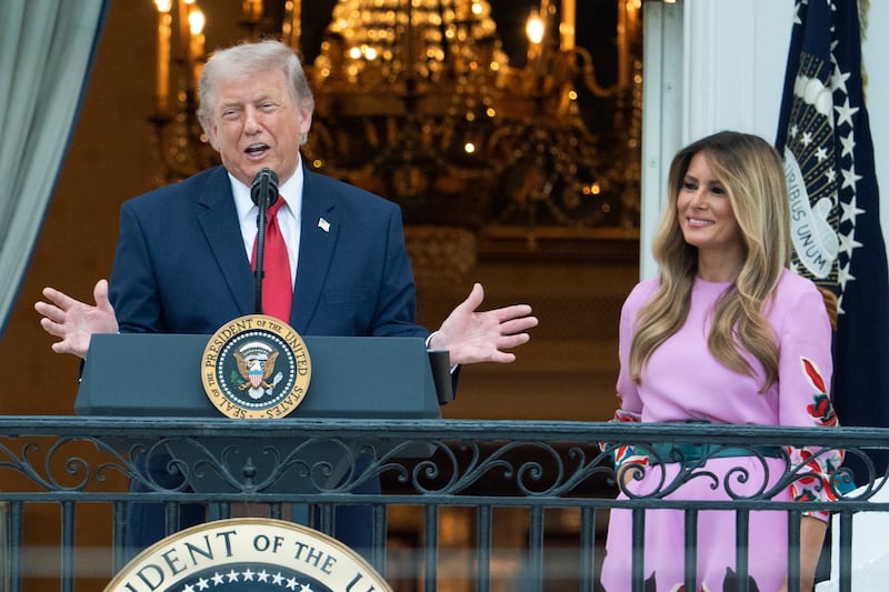 President Donald Trump with first lady Melania Trump addresses the attendees from the Blue Room Balcony of the White House during the annual Congressional Picnic on the South Lawn, Tuesday, May 19, 2026, in Washington. (AP Photo/Manuel Balce Ceneta)