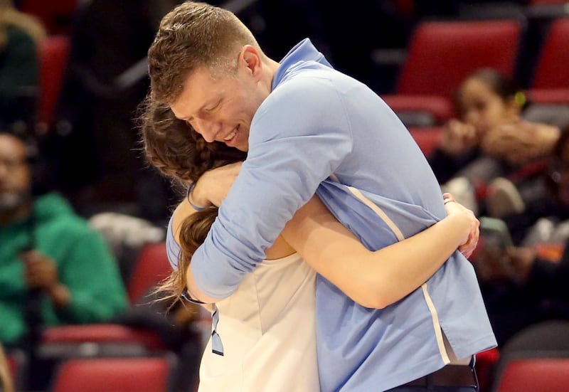 Cissna Park head girls basketball coach Anthony Videka hugs senior Julia Edelman during the Class 1A third place game on Friday, March 7, 2025 at CEFCU Arena in Normal.