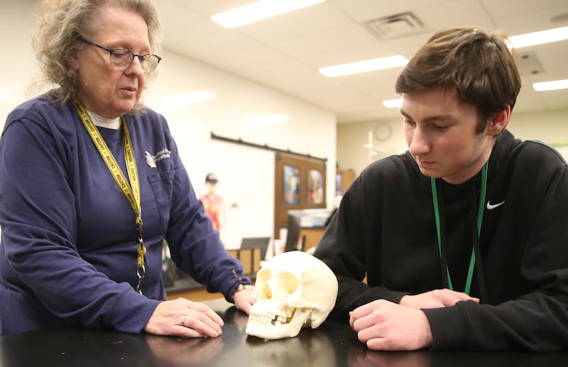 Nancy Kochis, forensic science teacher at La Salle-Peru Township High School helps student Ryne Bubela identify parts of a human skull on Tuesday, March 11, 2025 at L-P High School.