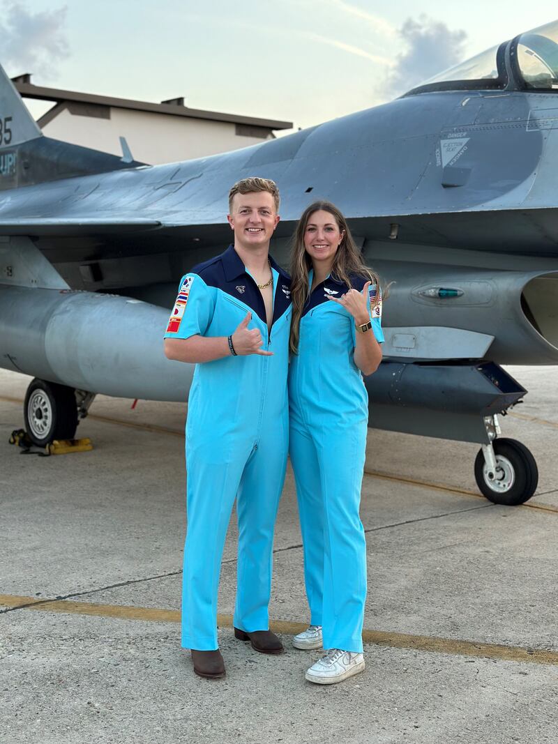 Air Force Captains Tanner Massey, a 2015 Sterling High School graduate, and his wife, Sydney Sheppard, serve side by side as fighter pilots in northern Japan. Here they are shown in front of an F-16 in their party suits (a fighter pilot tradition) when they were stationed at Kunsan Air Base, South Korea, while assigned to the 35th Fighter Squadron.