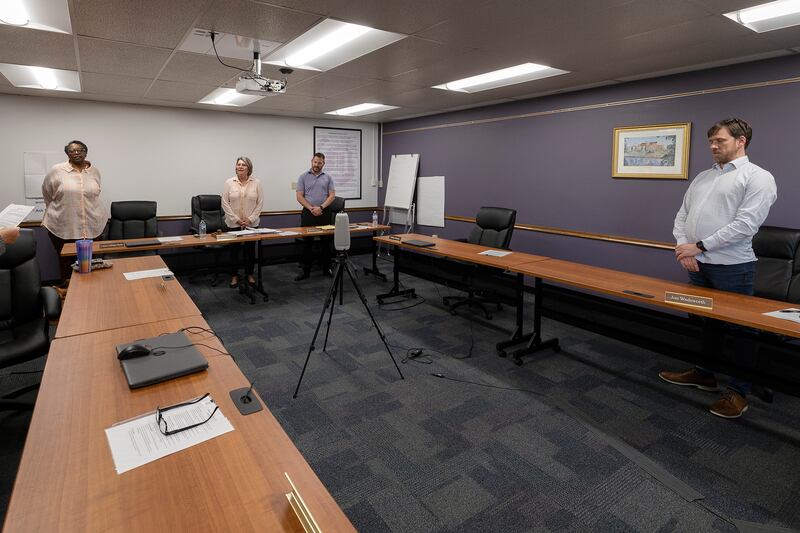 Dixon School Board members stand to take the oath Tuesday, May 6, 2025, during a meeting. The group was re-elected in April.
