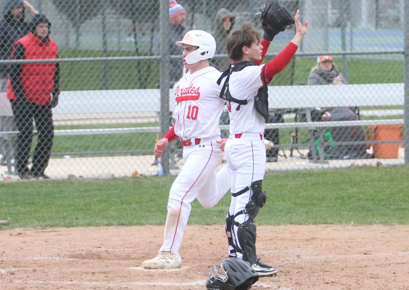 Ottawa's Jace Veith steps on home plate to score a run as Hall catcher Greyson Bickett holds off the throw on Tuesday, April 1, 2025 at Ottawa High School.