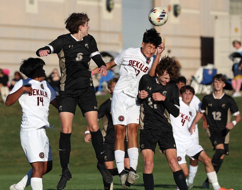 DeKalb's Nathan Ramirez heads the ball between two Sycamore players on a corner kick during the El Classicorn rivalry game Tuesday, Oct. 7, 2025, at Sycamore High School.