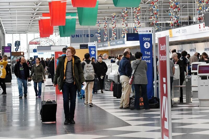 Passengers make their way through O'Hare International Airport's Terminal 1. Air travel is estimated to grow by 14% over the holiday, AAA estimates.