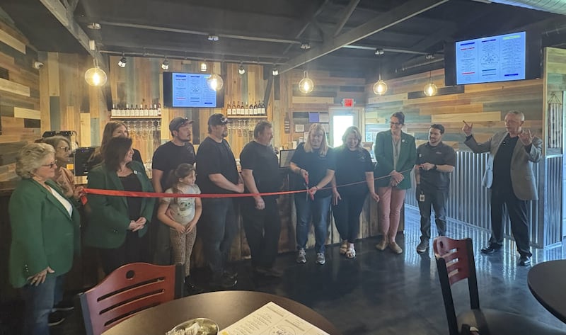 Stephanie Small cuts the ribbon alongside family members and representatives from the Ottawa Area Chamber of Commerce and its ambassadors during the official opening of Small Memories Meadery and Winery on Friday May 2, 2025.
