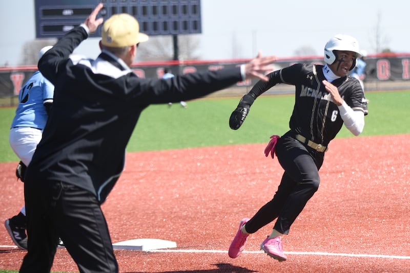 Bishop McNamara's Gavin Jones, right, is waved around third base by coach Aaron Fuerst during a game against Kankakee Saturday, March 28, 2026 at 315 Sports Park in Bradley.