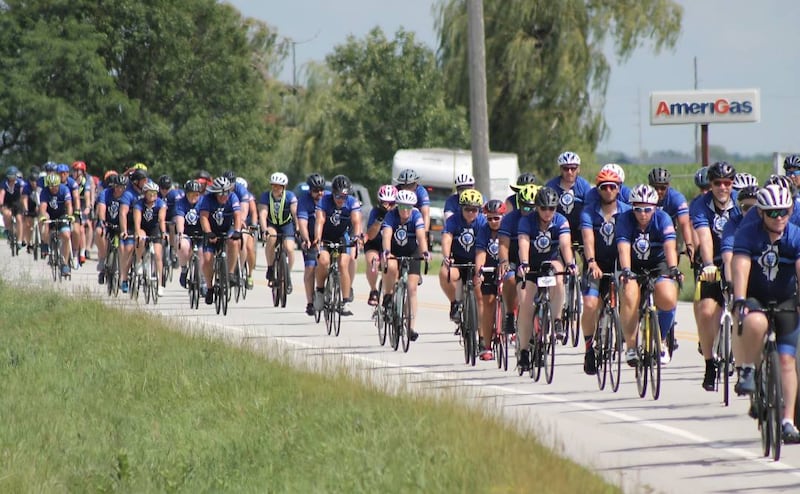 Cyclists participating in Cycle Across Illinois, a charity campaign to honor fallen police officers and raise funds for their families, bike from Normal to DeKalb on Saturday, July 12, 2025.