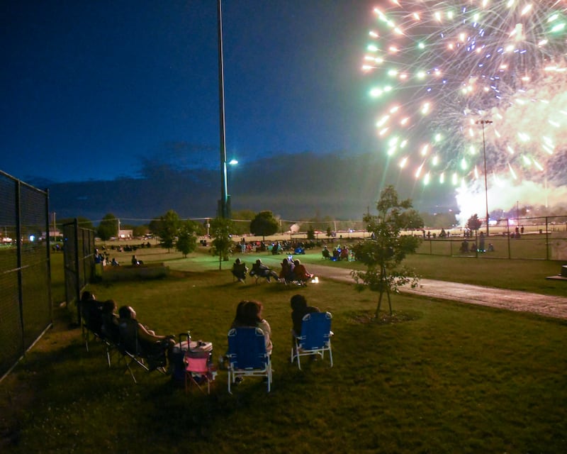Fireworks light up the night sky as community members watch the fireworks display at Prairie Point Community Park in Oswego on Thursday July 4, 2024.