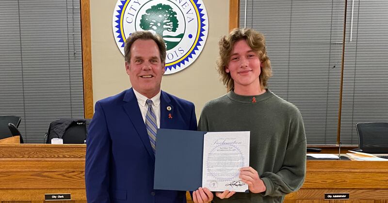 Geneva Mayor Kevin Burns presents Geneva High School junior Timothy McQueston with a proclamation for Red Ribbon Week, Oct. 23-31, 2025. McQueston is co-president of SADD – Students Against Destructive Decisions. This year's theme is 'Life is a Puzzle, Solve it Drug Free.