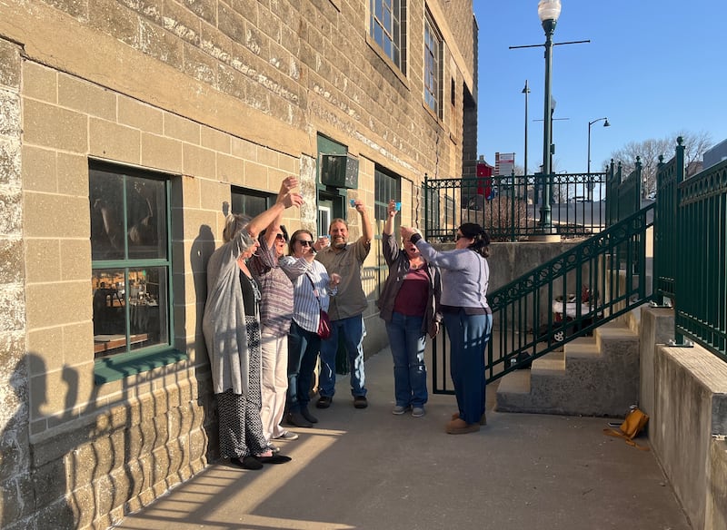 Board members of the nonprofit music organization Rosbrook celebrate the purchase of their new space at 90 S. Ottawa Ave in Dixon with a champagne toast Thursday, March 13, 2025.