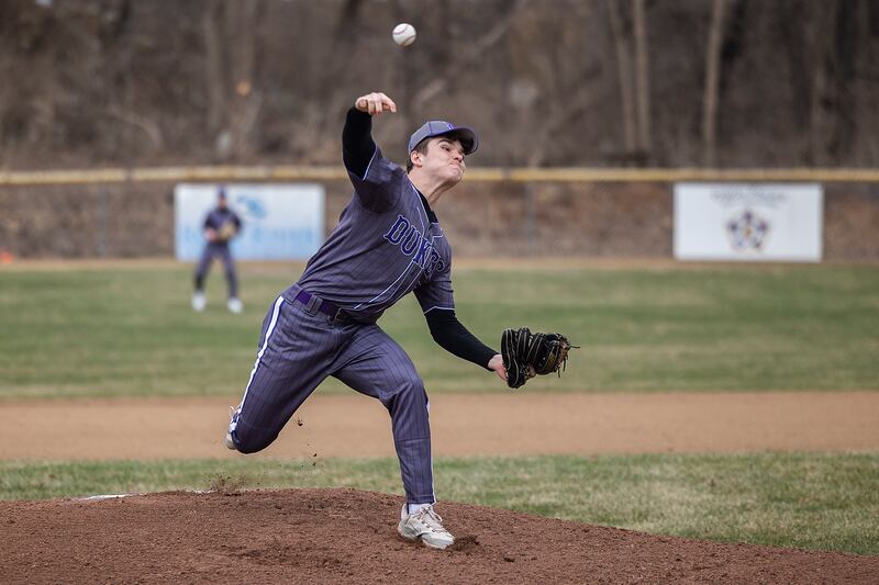 Dixon’s Daniel Fordham fires a pitch against DeKalb Friday, March 21, 2025.