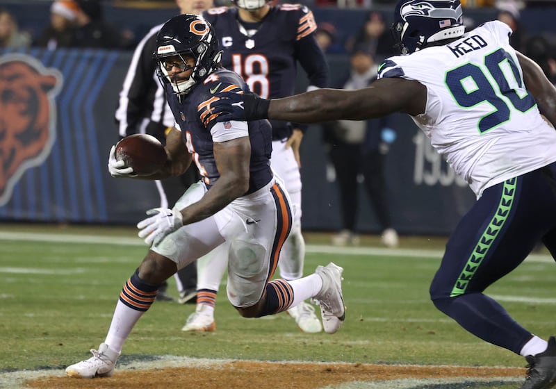 Chicago Bears running back D'Andre Swift tries to get outside of Seattle Seahawks defensive tackle Jarran Reed during their game Sunday, Dec. 26, 2024, at Soldier Field in Chicago.
