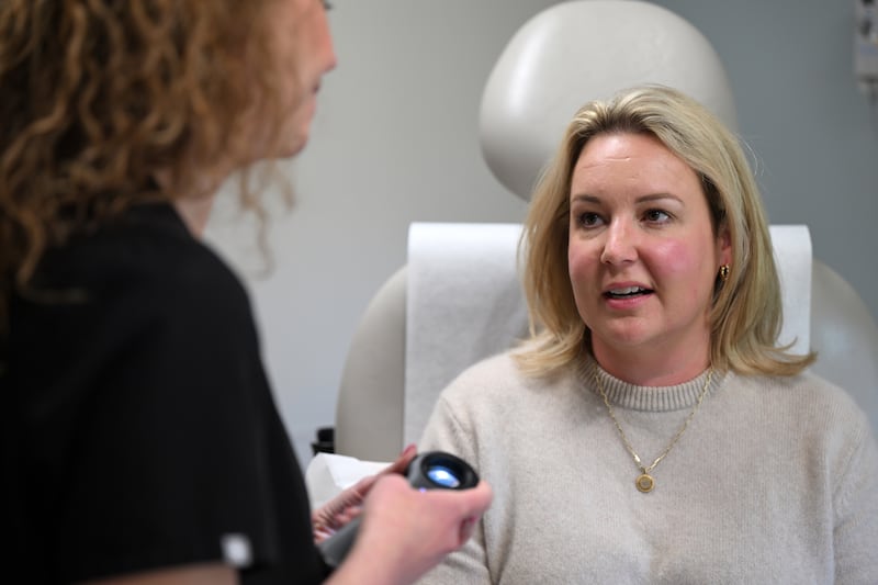 Wheaton mom Ashley Daly speaks with her Northwestern Medicine dermatologist, Dr. Lauren Taglia, in Naperville.