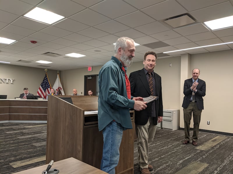 Kendall County Board member and Economic Development & Administration Committee Chair Dan Koukol presents Fox Valley Winery owner Mike Faltz with a Made in Kendall award at the Kendall County Board meeting on Tuesday, Feb. 17, 2026.