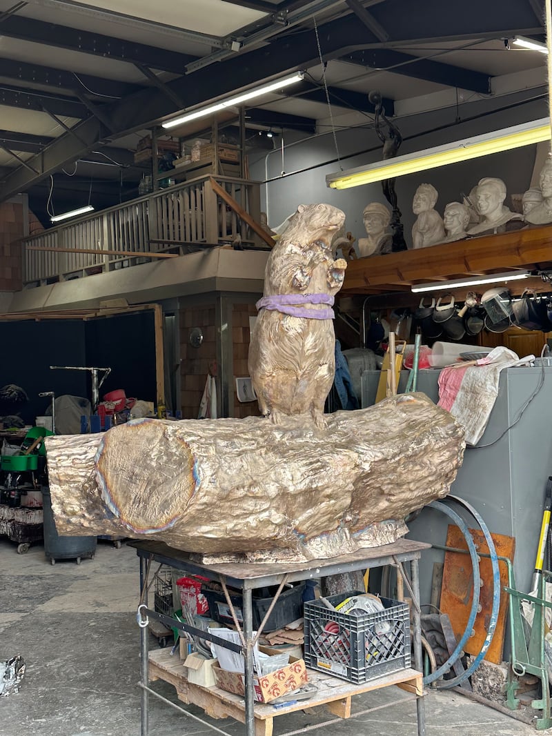 Erik Blome works on the Woodstock groundhog statue, Sunday, June 7, 2026