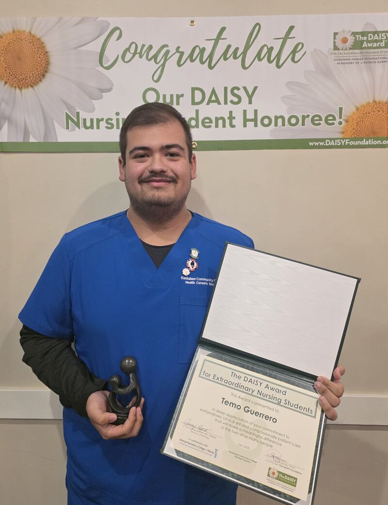 Temo Guerrero holds his DAISY Award® and sculpture on Dec. 11, 2025, at the Registered Nursing pinning.