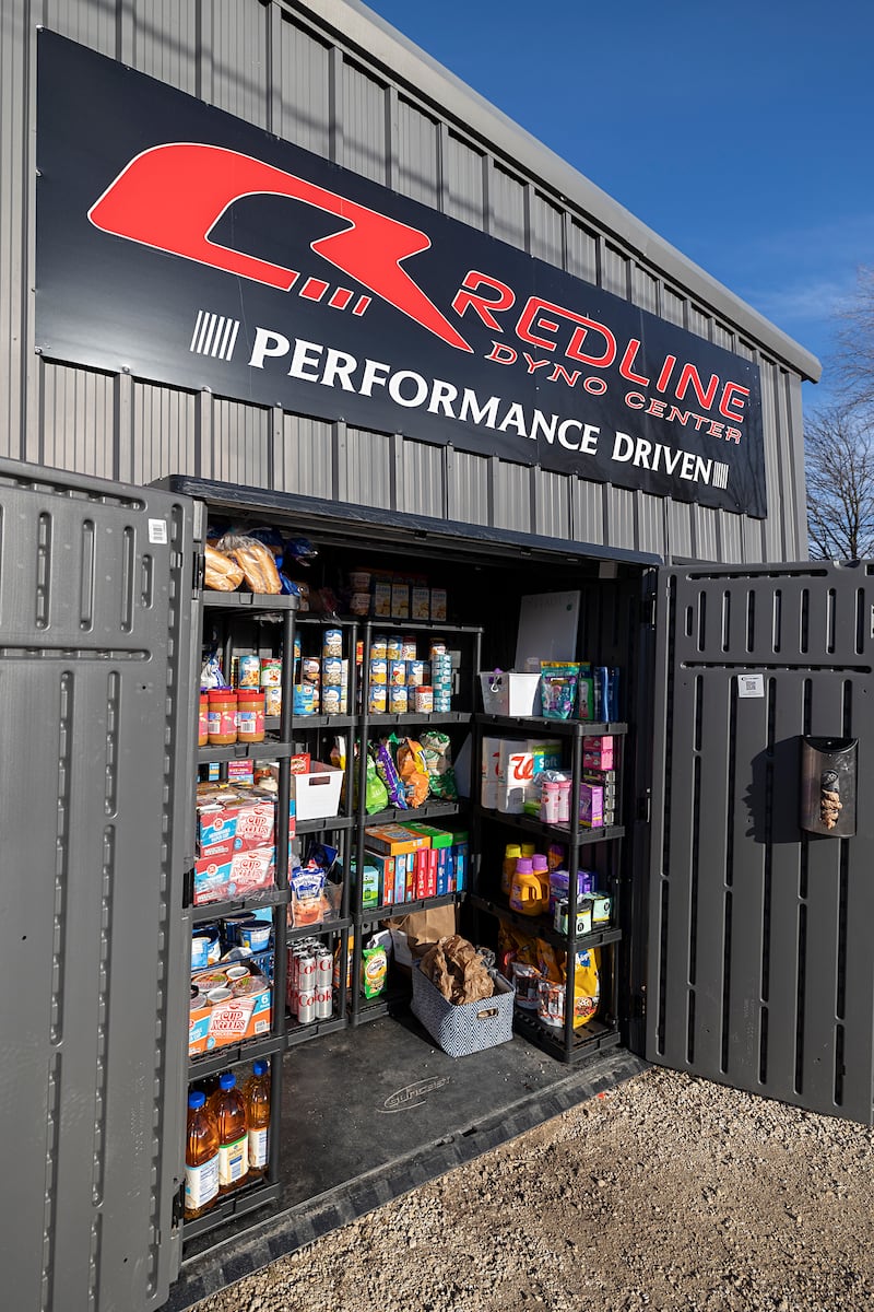 A free pantry sits outside of Redline Performance in Sterling Tuesday, Jan. 13, 2026, Cam and Courtney Plotner set up the shed for those who need a little extra help on food and hygiene staples. The pantry contains things like canned and boxed foods, soaps and pet food.