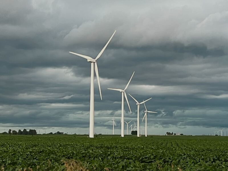 Storm clouds settle over windmills in farm fields along Illinois Route 23 between Waterman and DeKalb on Friday, July 11, 2025.