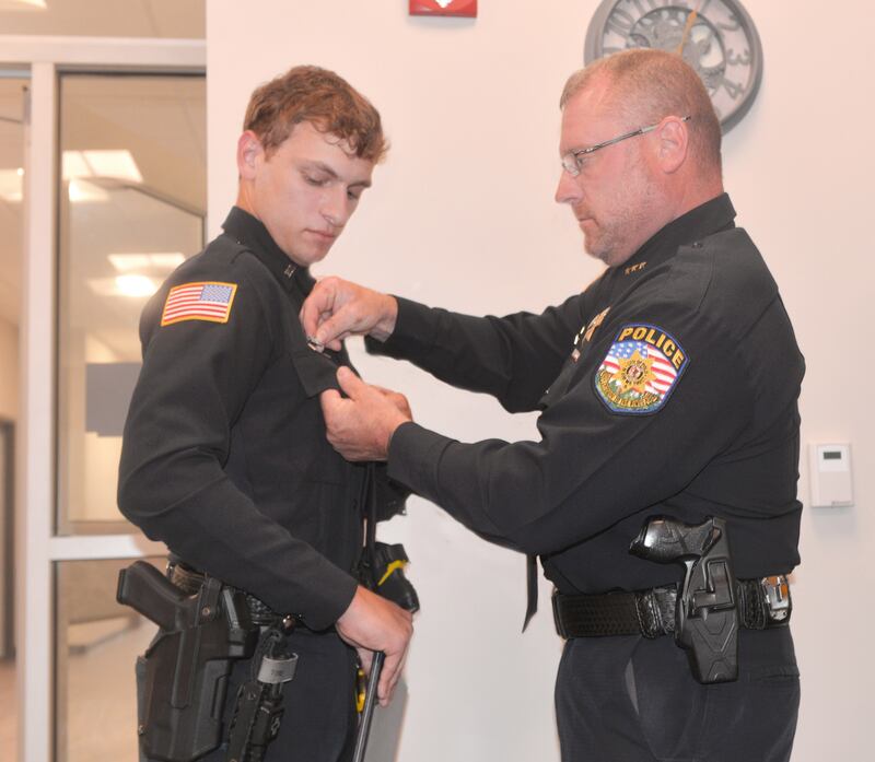 Polo Patrol Officer Kaden Coppotelli (left) receives an ILACP Lifesaving Award pin from Polo Police Chief Matt Coppotelli on Monday, July 7, 2025 during the Polo City Council meeting. Matt is also Kaden's father.