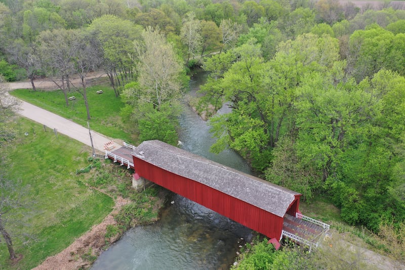 An aerial view of the Red Covered Bridge on Monday, April 27, 2026 in Princeton. The historic bridge remains closed as restoration plans move into the design phase. The 163-year-old bridge, which spans Big Bureau Creek was heavily damaged in 2023 after being struck by an oversized truck and is currently braced while repair plans continue to develop.