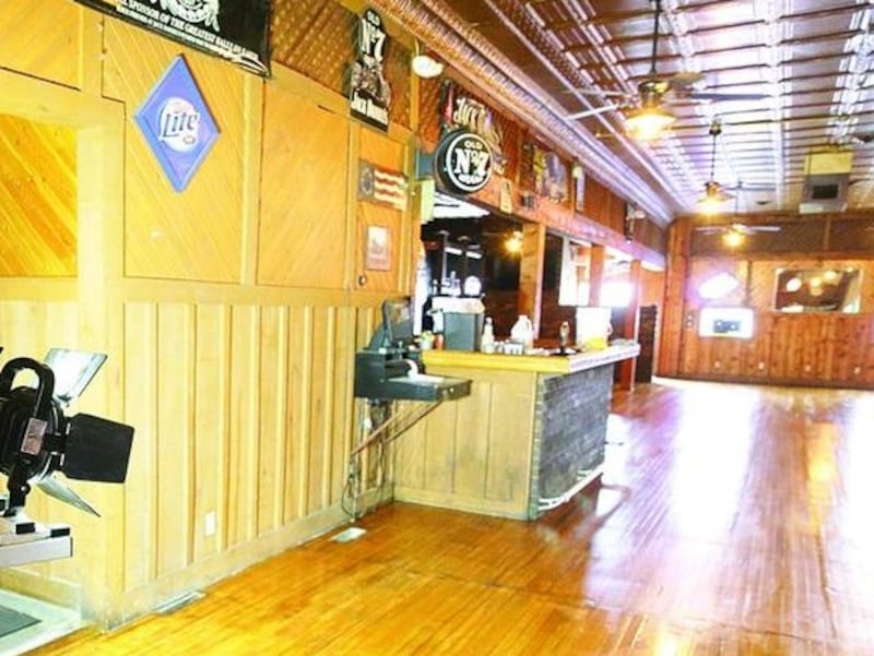Keith Brown, owner of Skooner'z Grill and Bar in Princeton, flips a light switch on a portable floodlight before doing a second coat of floor wax in the dining room. Brown is taking his profits from his business and donating them to his employees during the time the grill and bar is closed due to the coronavirus pandemic.