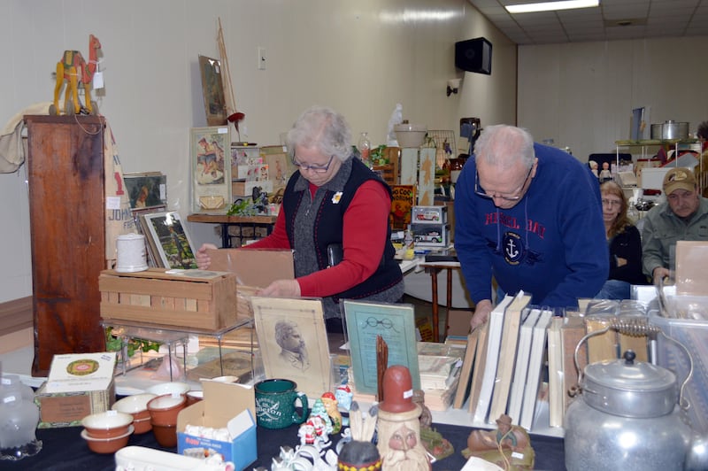 Molly and Ed Baker, of Mt. Morris, look through old newspapers and post cards during the annual February Finds Antique & Collectable Market on Feb. 4. The event was held at the Mt. Morris Moose Lodge 1551 Family Center and hosted more than 20 sellers.