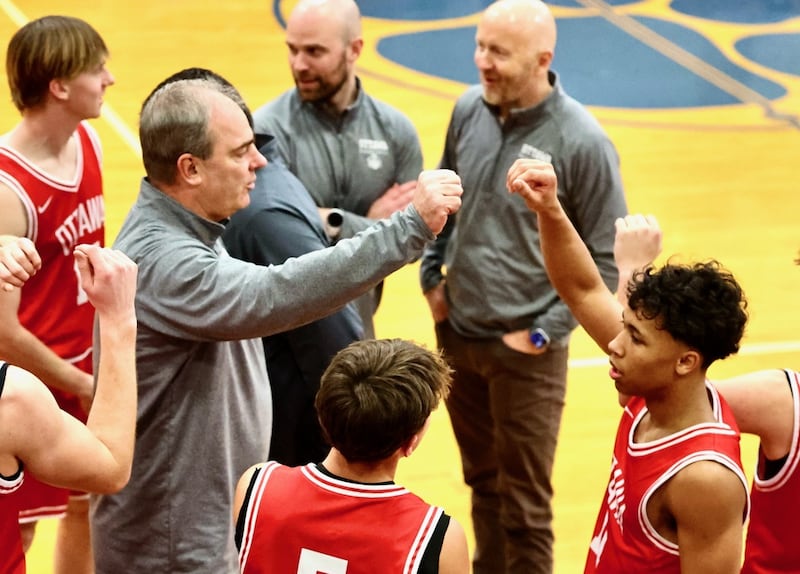 Ottawa coach Mark Cooper huddles up the Pirates in Tuesday's game at Princeton. He reflected on his memories playing and coaching at Prouty Gym after what stands to be his final game.