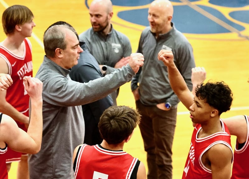 Ottawa coach Mark Cooper huddles up the Pirates in Tuesday's game at Princeton. He reflected on his memories playing and coaching at Prouty Gym after what stands to be his final game.