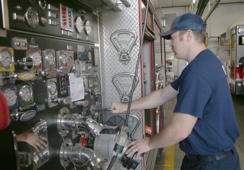 Veteran and Ottawa fireman Brian Ksaizak, performs routine maintenance on a fire engine on Monday, Oct. 6, 2025 at the Ottawa Fire Station.
