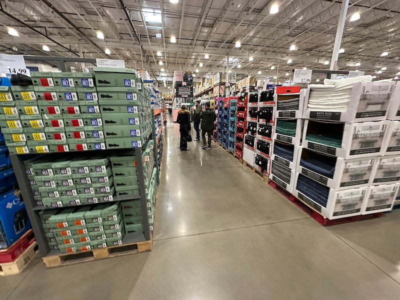 FILE - Shoppers make their ways down an aisle lined with clothing and shoes in a Costco warehouse Thursday, Jan. 23, 2025, in Sheridan, Colo. (AP Photo/David Zalubowski, File)