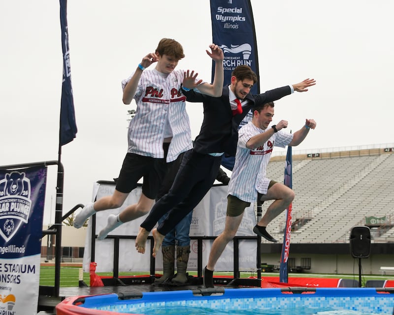 Members of the Phi Kappa Psi fraternity at NIU jump into the pool during the Polar Plunge event held at Huskie Stadium in DeKalb.